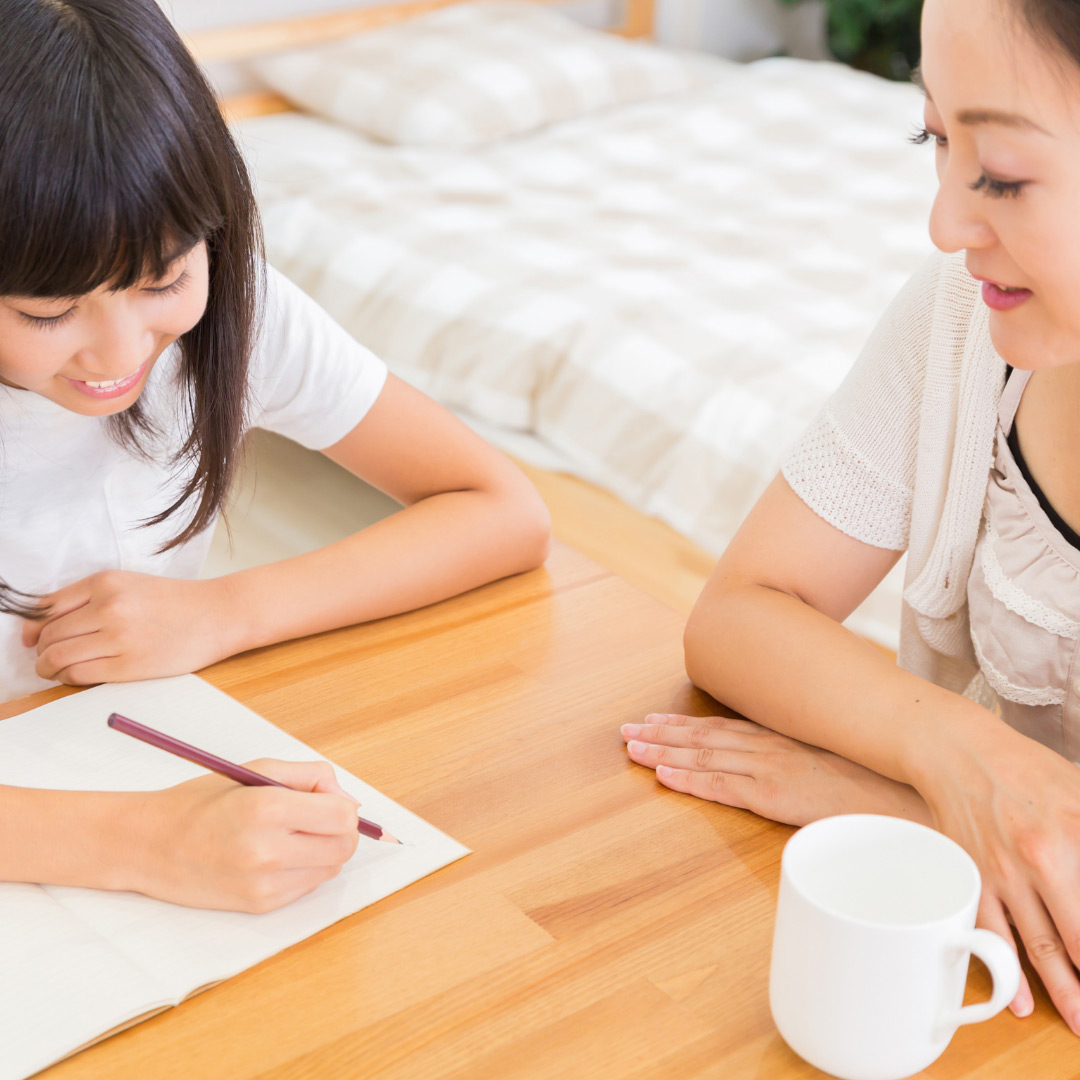 parent with intermediate child doing homework